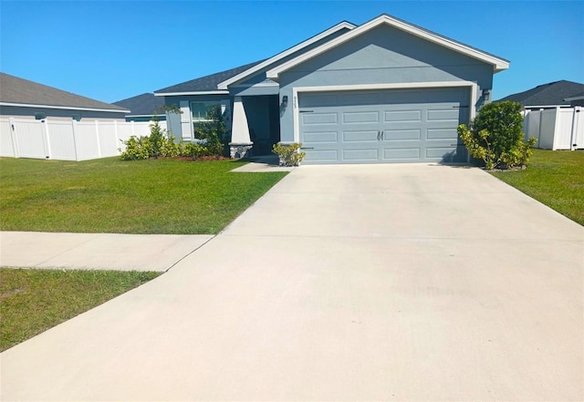 ranch-style house featuring a garage, driveway, and a front lawn