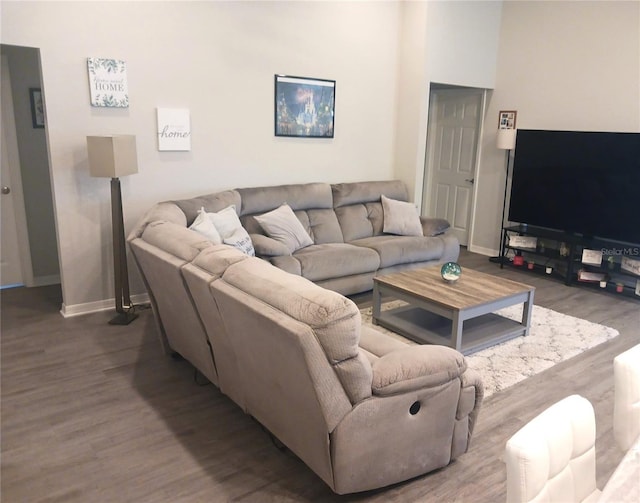 living area featuring baseboards and wood finished floors