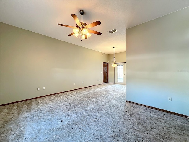 unfurnished room featuring baseboards, a ceiling fan, visible vents, and light carpet