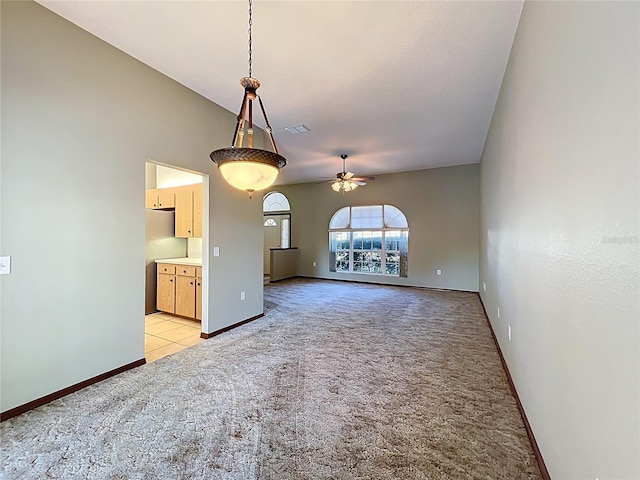 spare room featuring ceiling fan, baseboards, visible vents, and light carpet