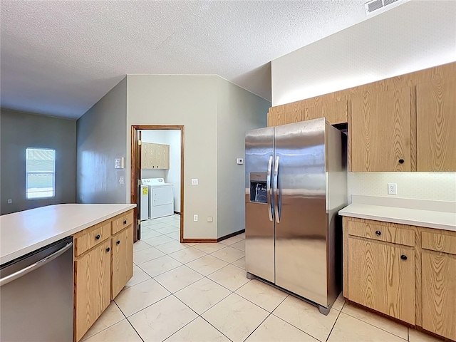 kitchen with stainless steel appliances, a textured ceiling, light brown cabinets, and light countertops