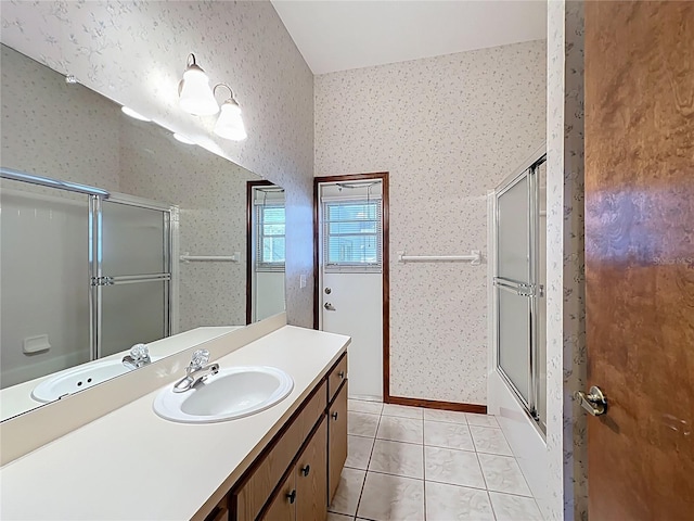 full bath featuring tile patterned floors, combined bath / shower with glass door, wallpapered walls, and vanity