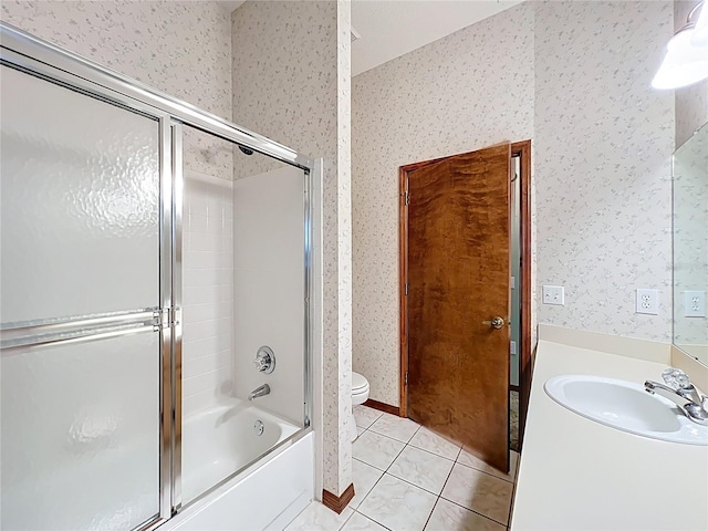 bathroom with vanity, shower / bath combination with glass door, wallpapered walls, tile patterned floors, and toilet