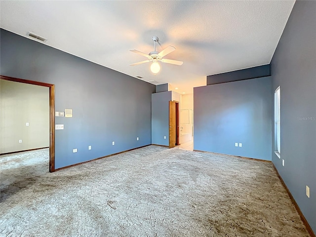 unfurnished bedroom with visible vents, a textured ceiling, baseboards, and carpet floors