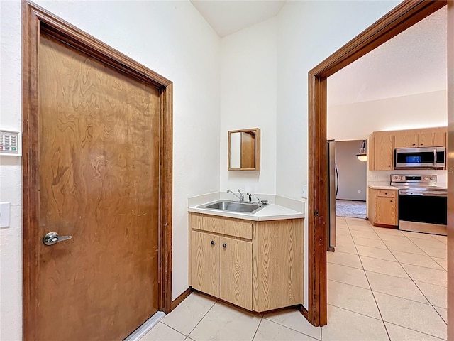 bathroom featuring tile patterned floors, baseboards, and a sink