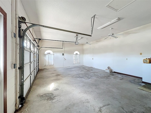 garage featuring a garage door opener and a ceiling fan