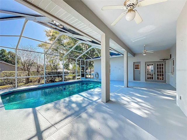 outdoor pool with a patio, french doors, a lanai, and ceiling fan