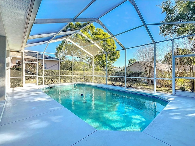 view of pool featuring glass enclosure, a patio, and a fenced in pool