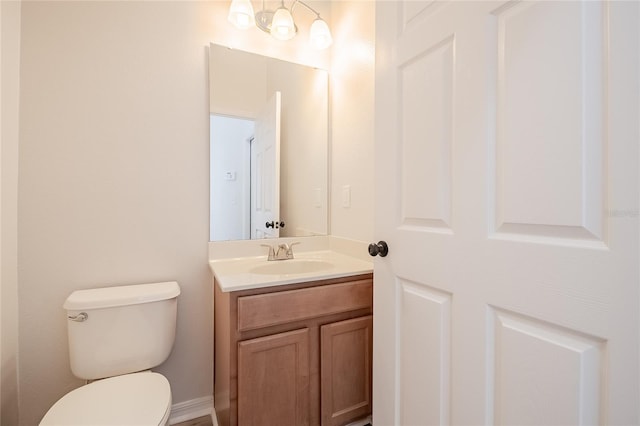 bathroom featuring toilet and vanity