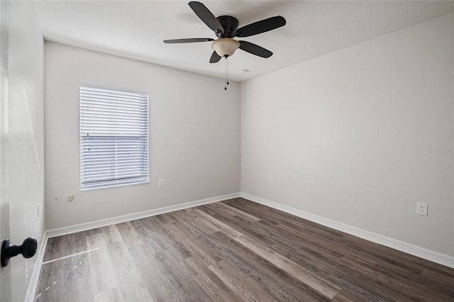 empty room with wood finished floors, baseboards, and ceiling fan