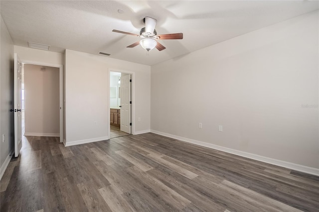 unfurnished bedroom featuring a ceiling fan, baseboards, visible vents, and dark wood-style flooring