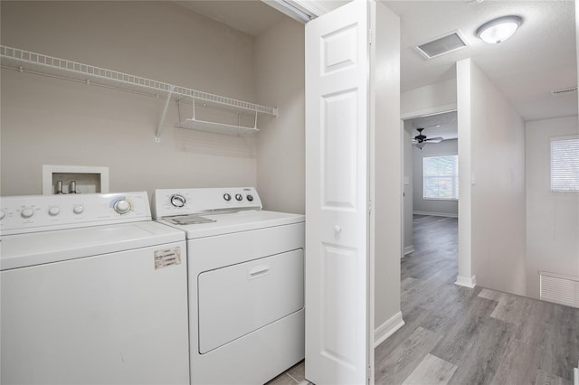 washroom featuring laundry area, independent washer and dryer, light wood-style flooring, and visible vents