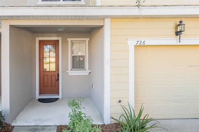 doorway to property with a garage