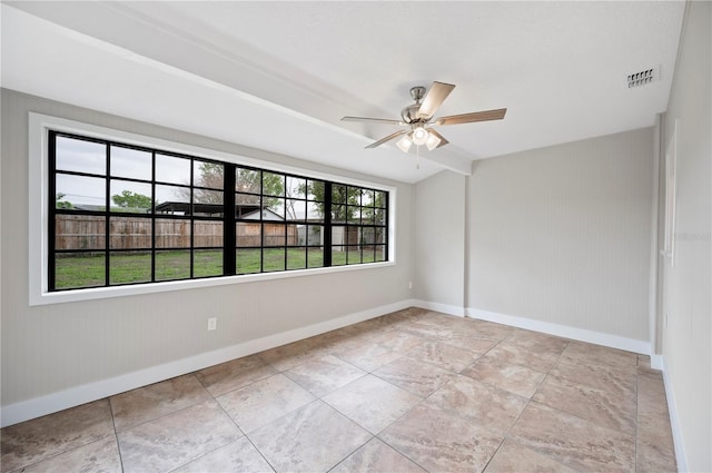 empty room with visible vents, baseboards, and ceiling fan