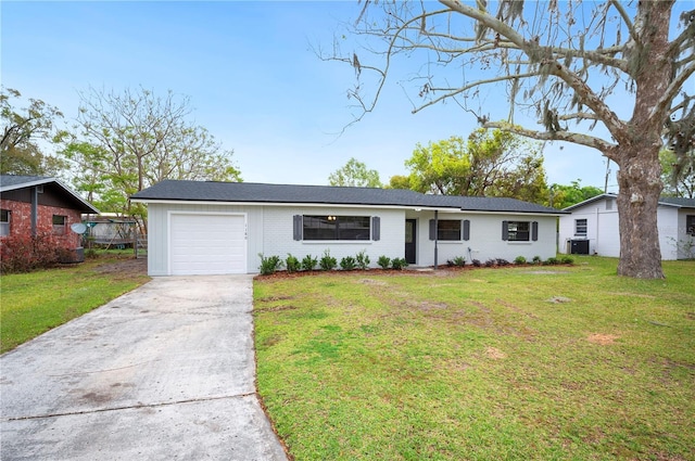 single story home with driveway, cooling unit, a front yard, an attached garage, and brick siding