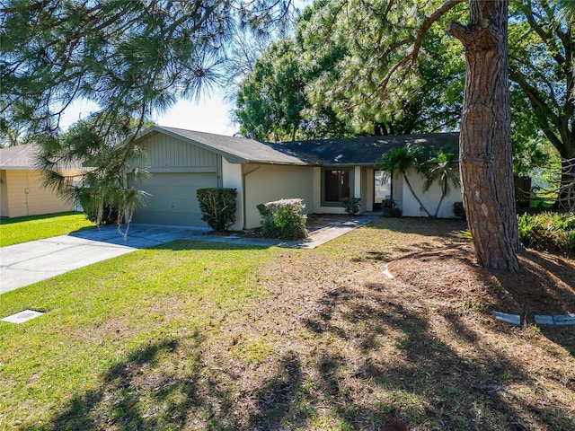 ranch-style home featuring a front lawn, a garage, and driveway