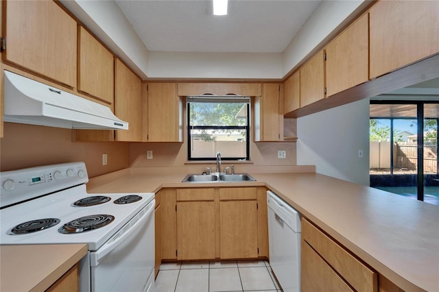 kitchen featuring under cabinet range hood, white appliances, light countertops, and a sink