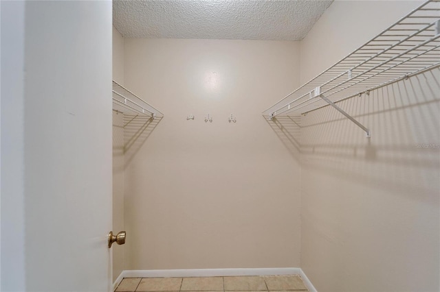 walk in closet featuring light tile patterned floors