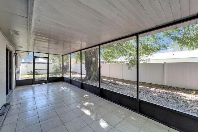 unfurnished sunroom featuring visible vents