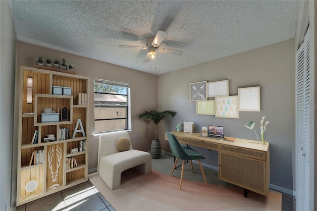 home office featuring baseboards, a textured ceiling, and a ceiling fan