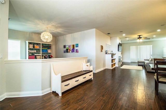 interior space featuring visible vents and ceiling fan with notable chandelier