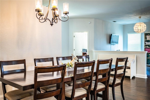 dining area featuring dark wood finished floors and a chandelier