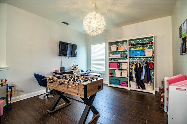 game room with visible vents, baseboards, a notable chandelier, and wood tiled floor