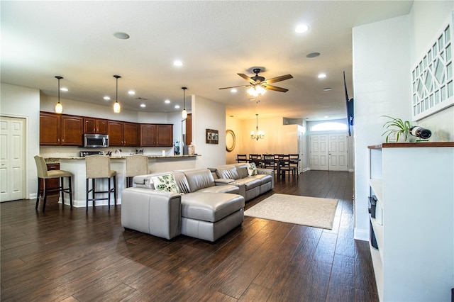 living area with recessed lighting, baseboards, a ceiling fan, and dark wood-style flooring