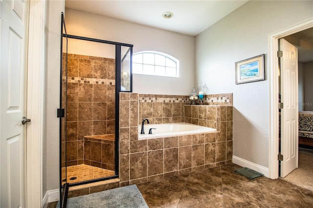 full bath with tile patterned floors, a bath, baseboards, and a stall shower