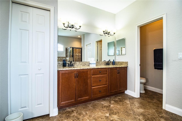 bathroom featuring a shower stall, toilet, double vanity, and a closet