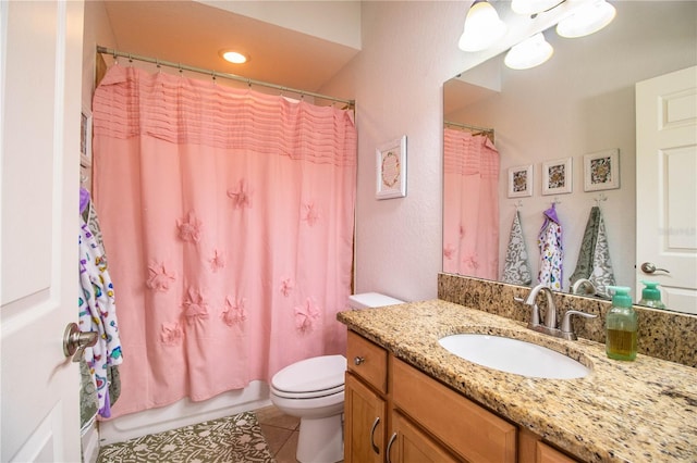 bathroom featuring vanity, tile patterned floors, toilet, and shower / bath combo with shower curtain