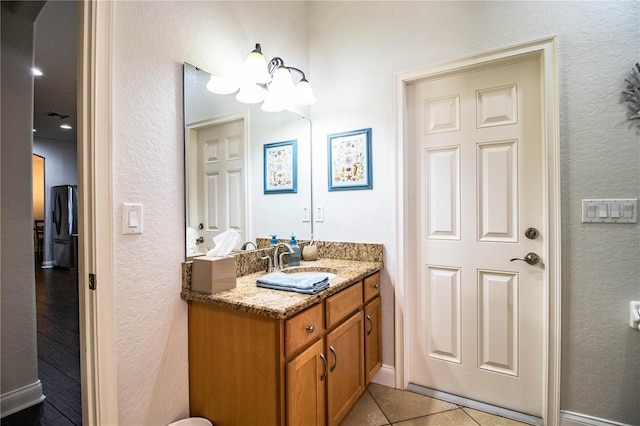 bathroom featuring visible vents, vanity, and tile patterned flooring