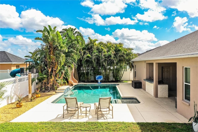 view of swimming pool with a fenced backyard, a fenced in pool, a water slide, and a patio