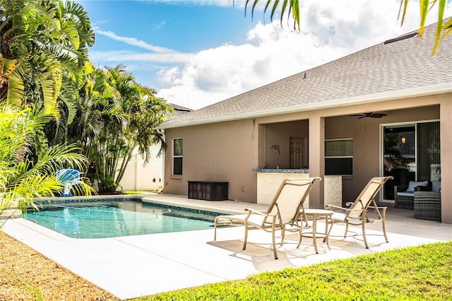 outdoor pool featuring ceiling fan and a patio area