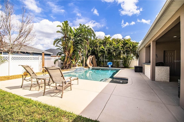 view of pool with a fenced in pool, a water slide, a fenced backyard, and a patio area