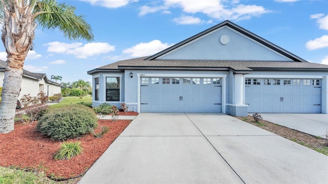 single story home featuring stucco siding, an attached garage, and concrete driveway