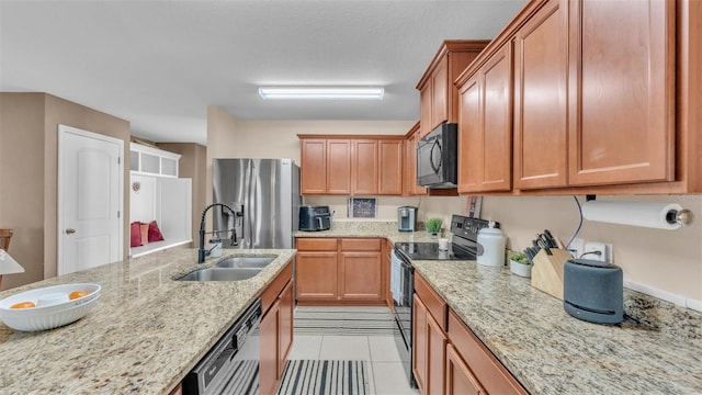 kitchen featuring a sink, light stone countertops, black appliances, and light tile patterned floors