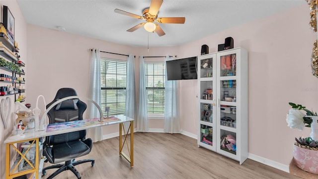 home office with ceiling fan, baseboards, and wood finished floors