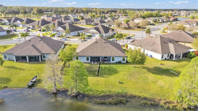 birds eye view of property featuring a residential view and a water view