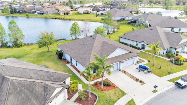 aerial view with a residential view and a water view