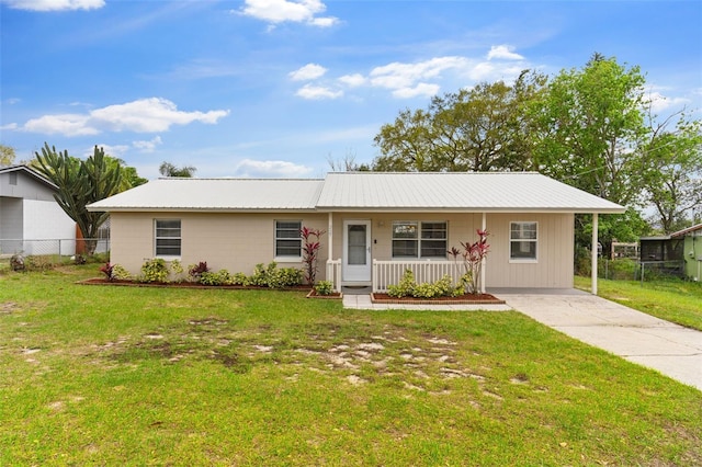 single story home featuring a front yard, fence, covered porch, and metal roof