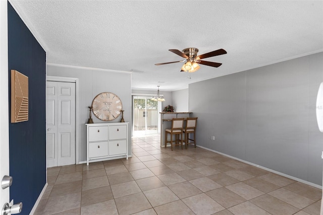 spare room featuring visible vents, a textured ceiling, ornamental molding, and ceiling fan with notable chandelier