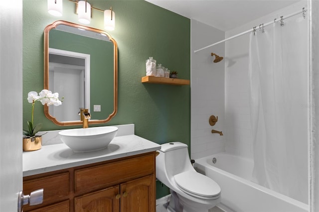 full bath featuring vanity, toilet, a textured wall, and shower / bath combo