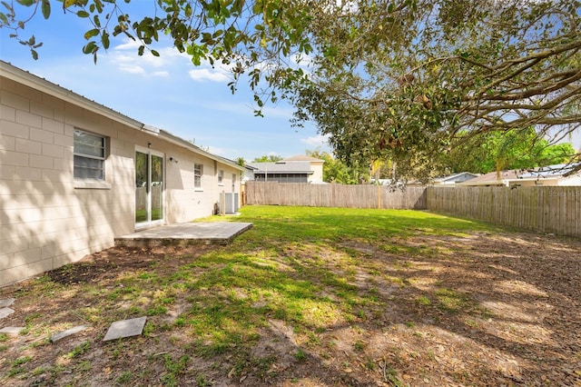 view of yard featuring central air condition unit, a patio, and a fenced backyard