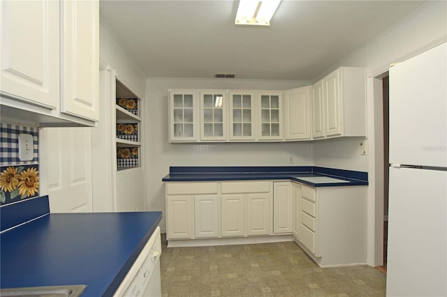 kitchen with dark countertops, visible vents, glass insert cabinets, white appliances, and white cabinetry