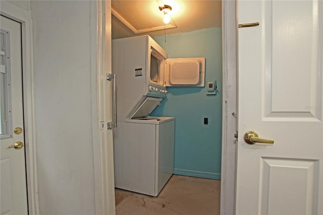 laundry room featuring laundry area, stacked washer / dryer, and attic access