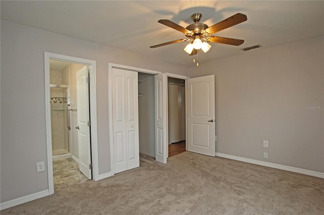 unfurnished bedroom featuring visible vents, connected bathroom, baseboards, carpet floors, and a closet