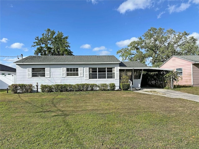 single story home featuring a carport, driveway, and a front yard