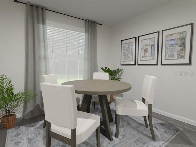 dining area featuring wood finished floors and baseboards