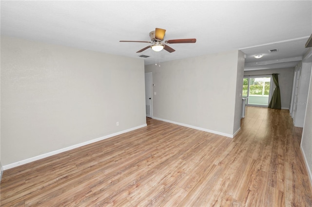 unfurnished room with visible vents, light wood-style flooring, baseboards, and a ceiling fan